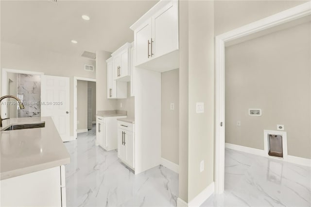 kitchen featuring sink and white cabinets