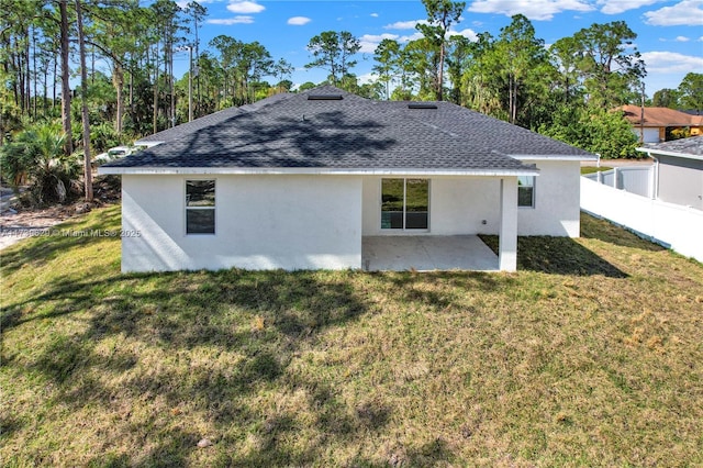 view of side of property with a yard and a patio