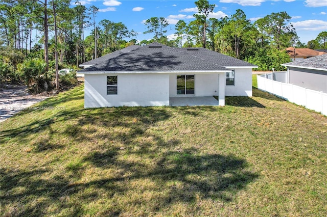 rear view of house with a yard