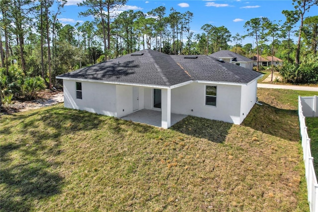 rear view of house with a patio area and a lawn