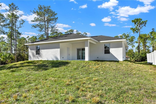 back of house with a lawn