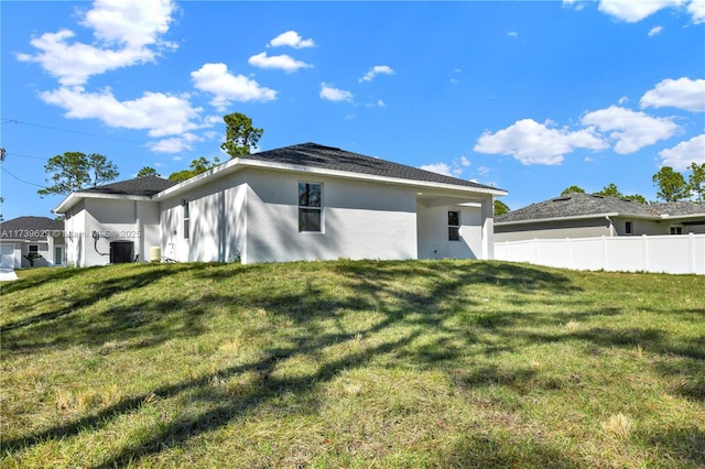 rear view of property featuring central AC unit and a yard