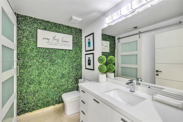 bathroom featuring vanity, tile patterned floors, and toilet