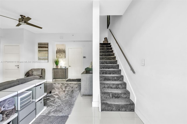 stairway featuring tile patterned flooring and ceiling fan