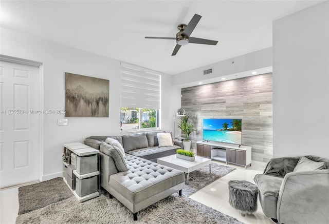 tiled living room with ceiling fan