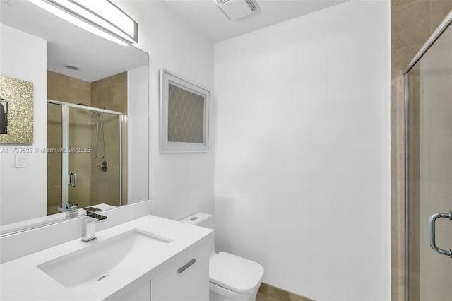 bathroom with walk in shower, vanity, and toilet