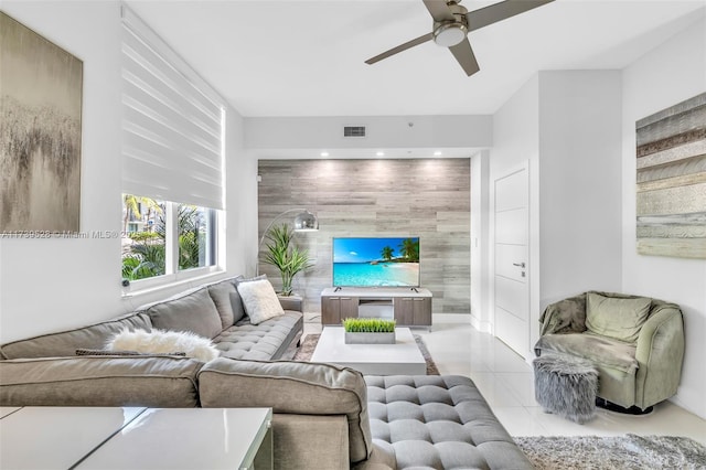 tiled living room with ceiling fan