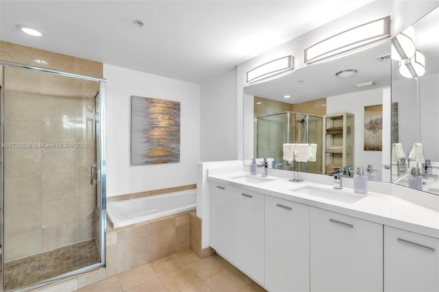 bathroom with tile patterned flooring, vanity, and shower with separate bathtub