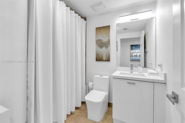 bathroom with vanity, tile patterned floors, and toilet