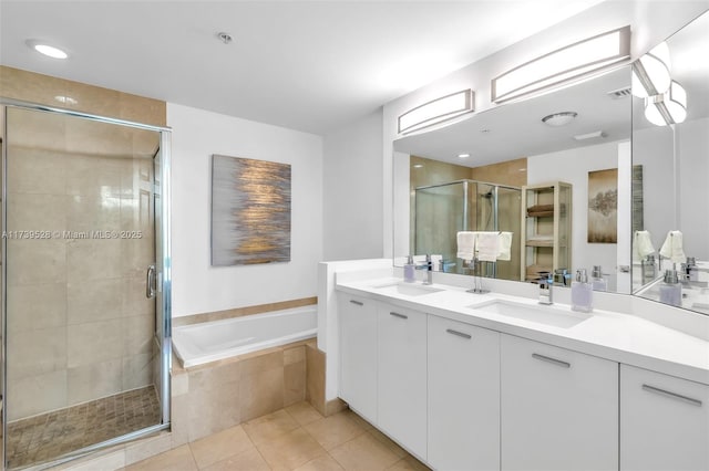 2138 Van Buren St Unit 606, Hollywood, FL 33020 - bathroom featuring a garden tub, a stall shower, tile patterned flooring, and a sink