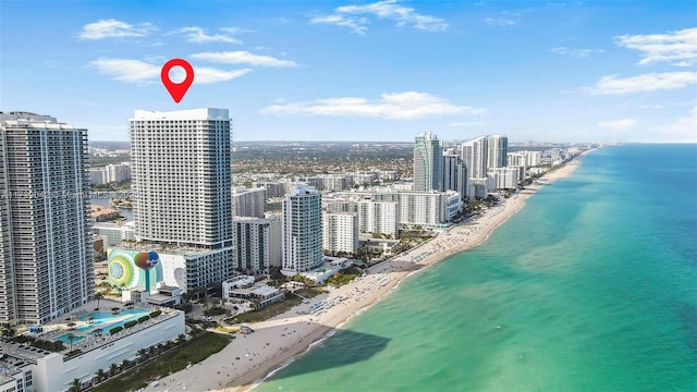 drone / aerial view with a water view and a view of the beach