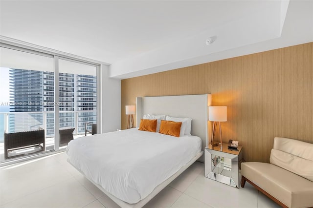 tiled bedroom featuring expansive windows