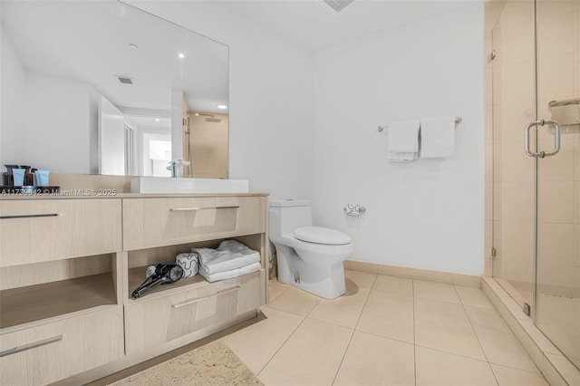 bathroom featuring an enclosed shower, vanity, tile patterned floors, and toilet