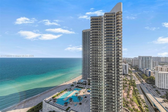 exterior space featuring a water view and a beach view