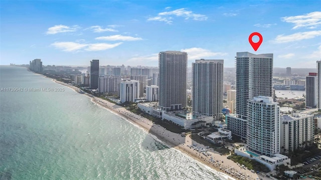 drone / aerial view featuring a water view and a beach view