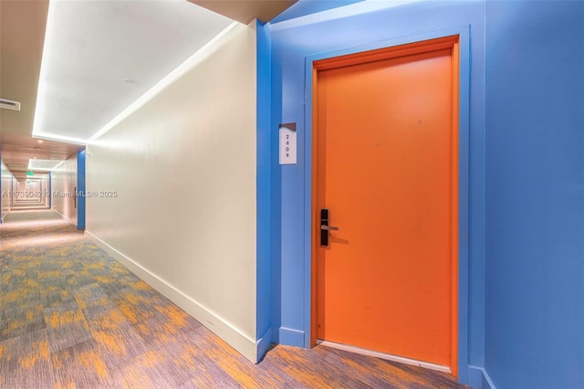 corridor with hardwood / wood-style flooring