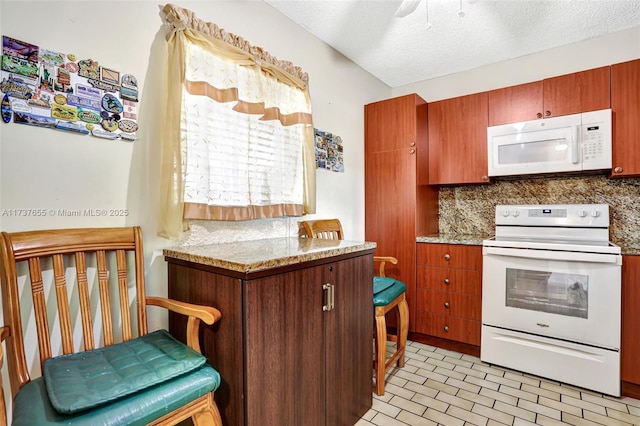 kitchen with tasteful backsplash, white appliances, light stone countertops, and a textured ceiling