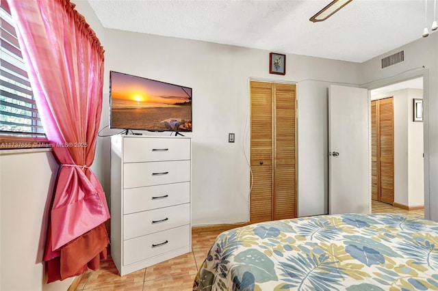 bedroom with ceiling fan, a closet, and a textured ceiling