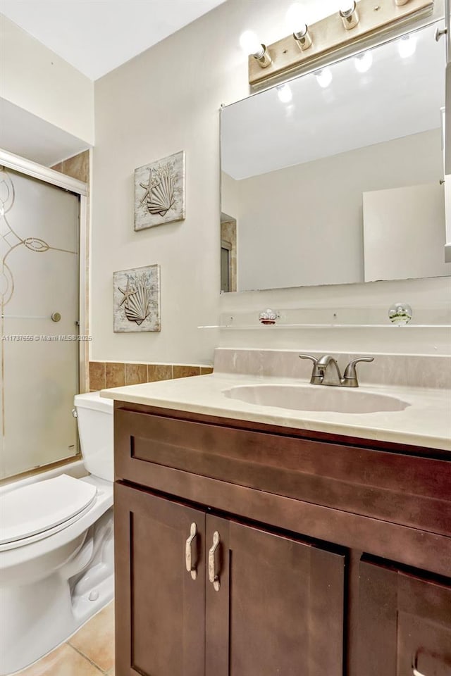 full bathroom featuring vanity, tile patterned floors, shower / bath combination with glass door, and toilet