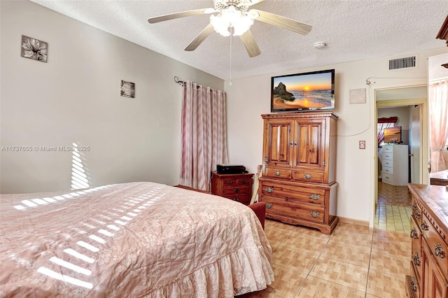 bedroom with ceiling fan, a textured ceiling, and light tile patterned floors