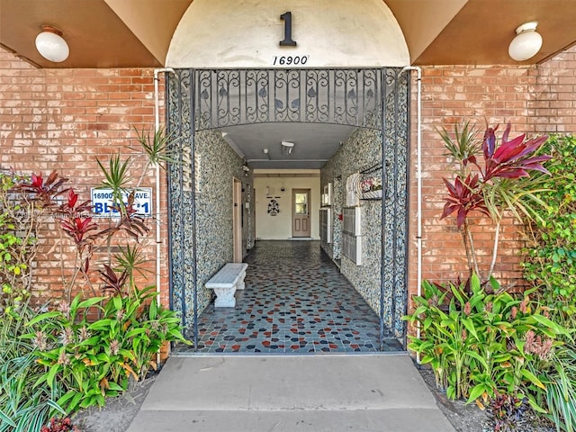 doorway to property featuring brick siding