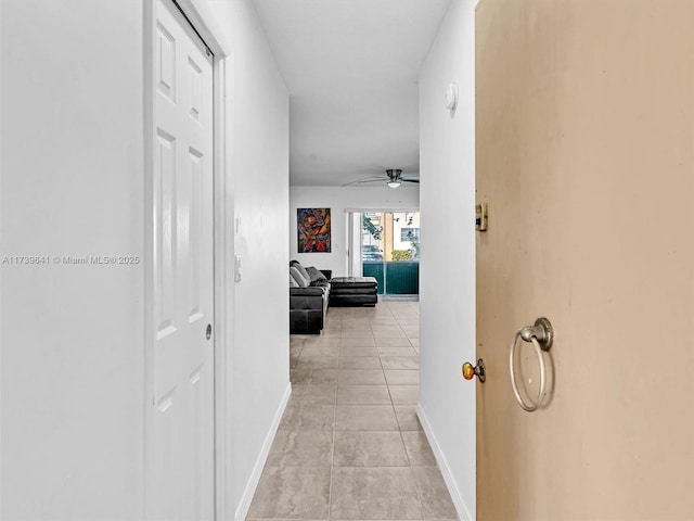 hall featuring light tile patterned flooring