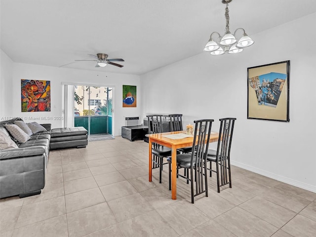 dining room featuring light tile patterned flooring, baseboards, and ceiling fan with notable chandelier