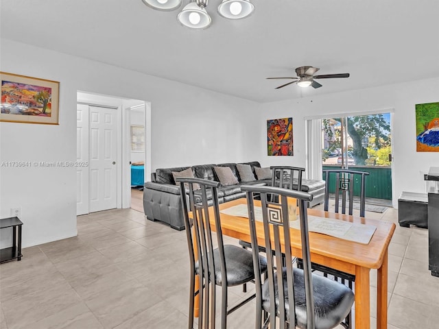 dining area featuring a ceiling fan and light tile patterned flooring