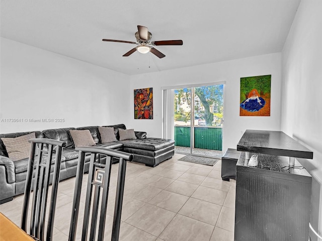 living area featuring light tile patterned floors and ceiling fan