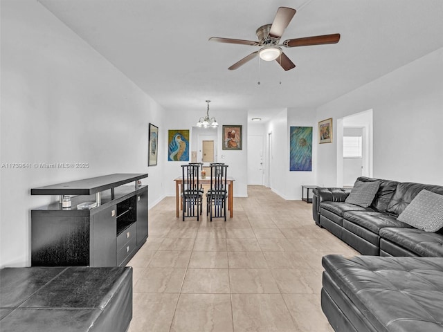 living room with ceiling fan with notable chandelier