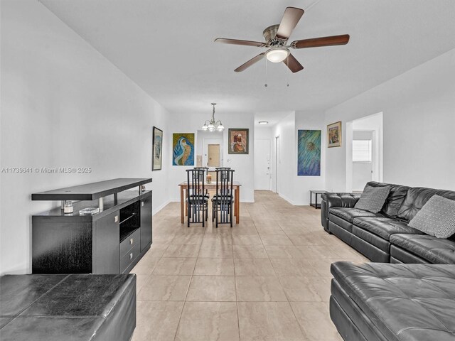 16900 NE 14th Ave Unit 115, Miami, FL 33162 - living area featuring a chandelier, a ceiling fan, and light tile patterned flooring