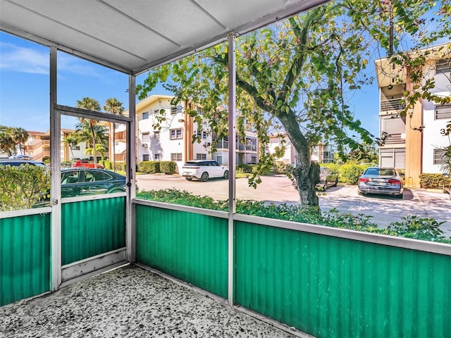 unfurnished sunroom featuring a residential view