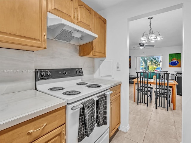 kitchen featuring light tile patterned floors, electric stove, light countertops, under cabinet range hood, and ceiling fan with notable chandelier