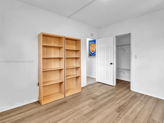 16900 NE 14th Ave Unit 115, Miami, FL 33162 - unfurnished bedroom with a spacious closet, light wood-style floors, and a closet