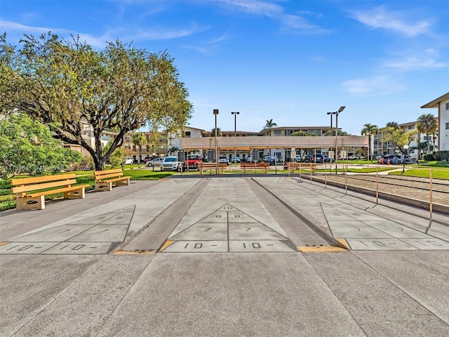 exterior space with uncovered parking and shuffleboard