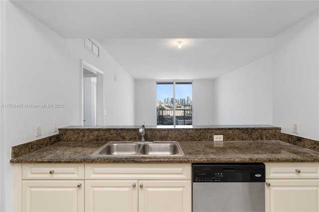 kitchen with stainless steel dishwasher, sink, and white cabinets