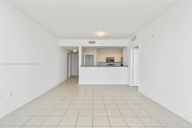 unfurnished living room with light tile patterned flooring