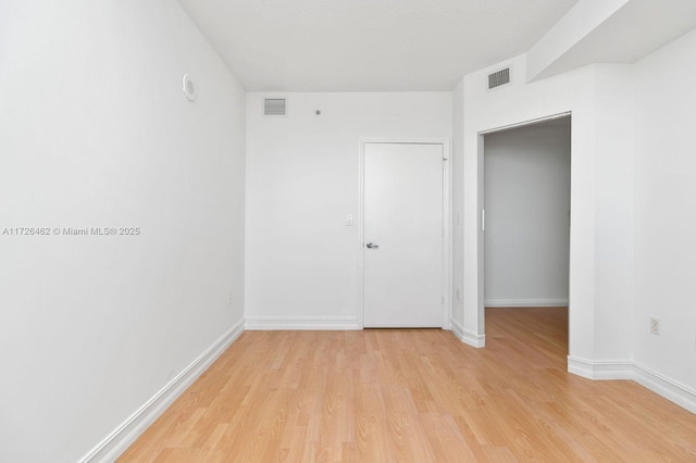 spare room with light hardwood / wood-style flooring