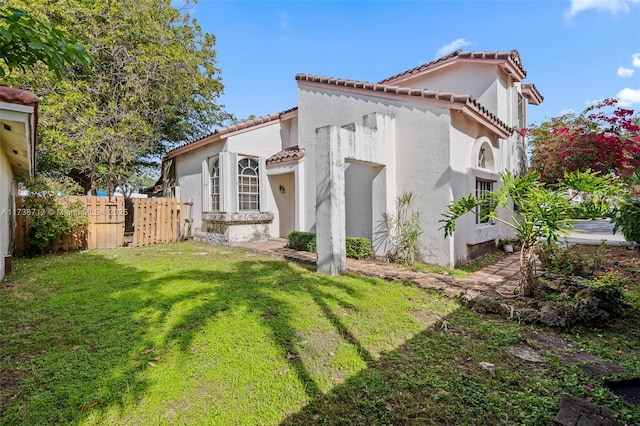 view of side of home featuring a yard