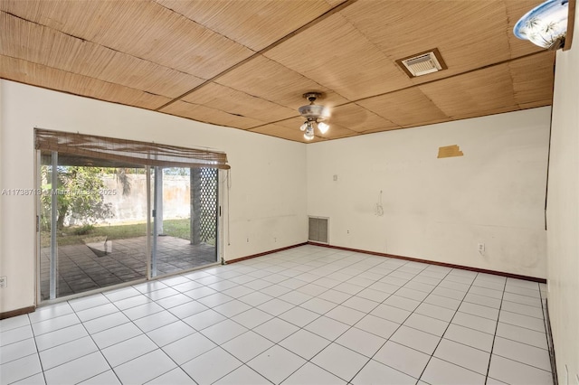 tiled empty room featuring ceiling fan and wooden ceiling