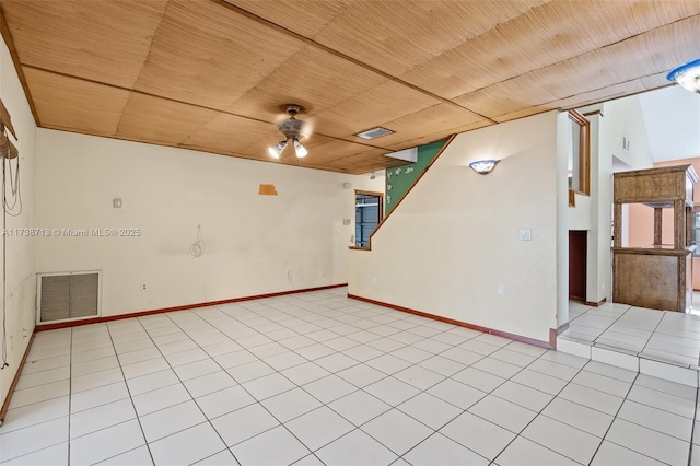 tiled empty room with wood ceiling and ceiling fan