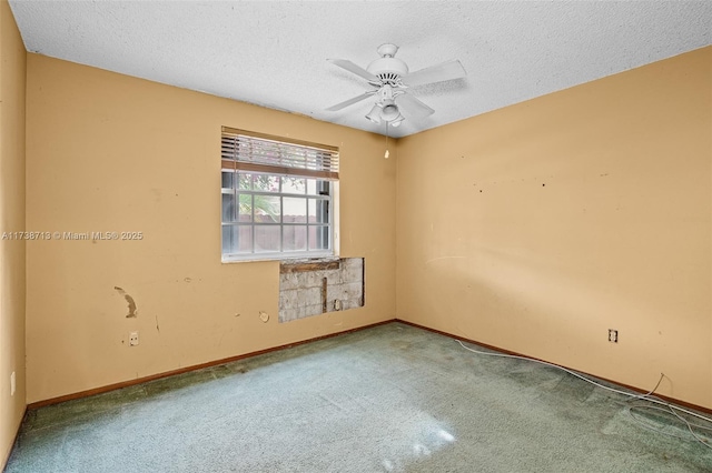 empty room with ceiling fan, a textured ceiling, and carpet flooring