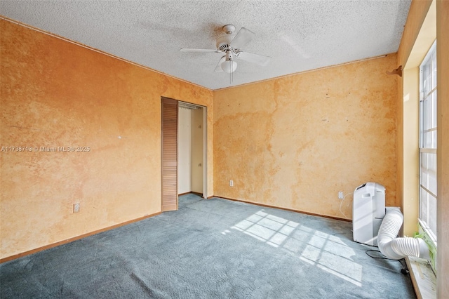 spare room with light carpet, ceiling fan, and a textured ceiling