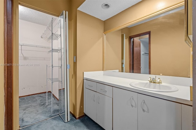 bathroom with vanity and a textured ceiling