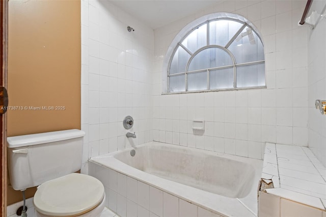 bathroom featuring tiled shower / bath and toilet