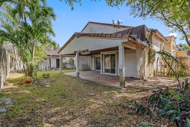 rear view of house with a yard and a patio