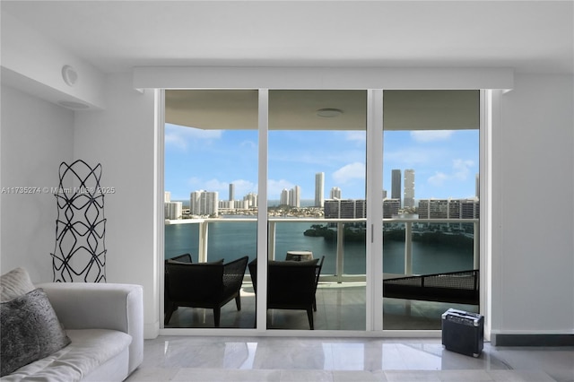 doorway to outside featuring expansive windows and a water view