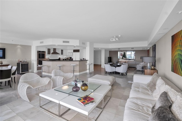 living room with light tile patterned floors and beverage cooler