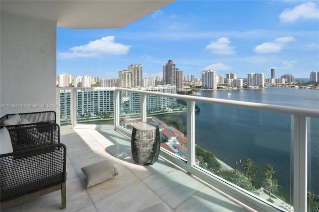 balcony featuring a water view and a view of city