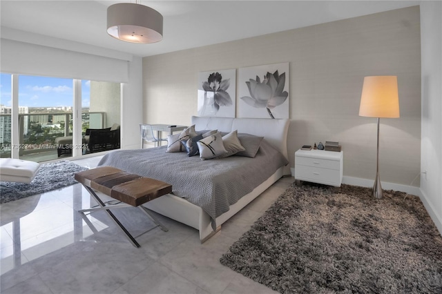 bedroom featuring tile patterned floors and baseboards